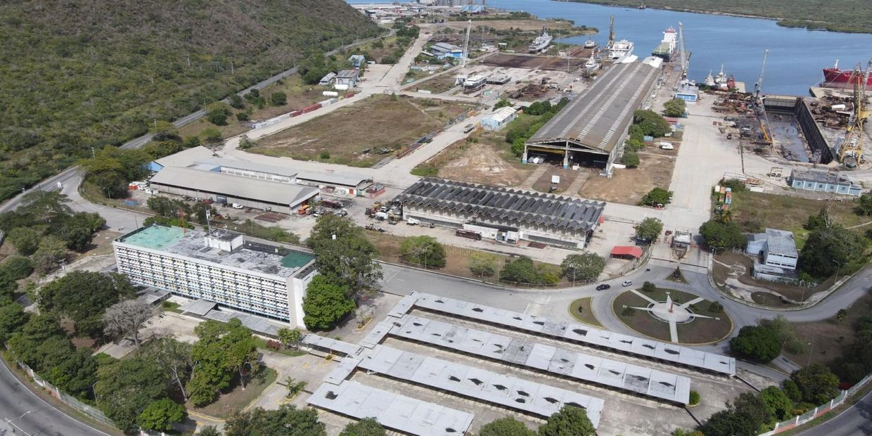 Aerial view of an industrial port area with warehouses and ships.