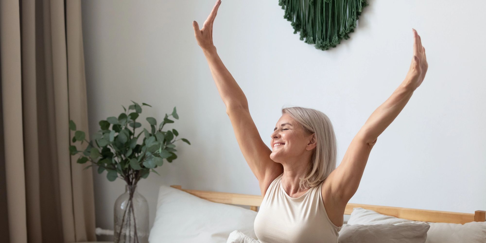 Woman after restful sleep, natural pain relief, improved wellness from light therapy in Snohomish.

