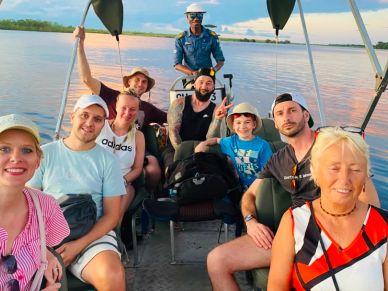 Group of people enjoying a boat ride on calm water.