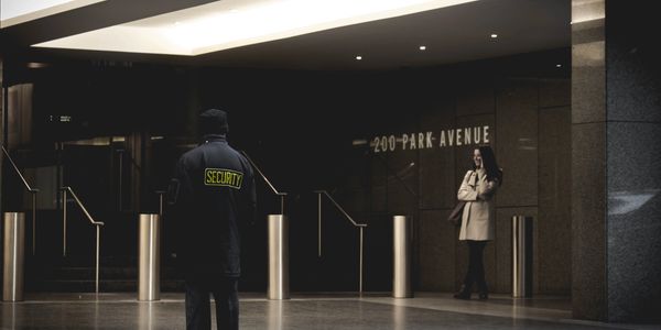 Security guard stands in front of 200 Park Avenue entrance.