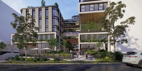 Modern multi-story building with greenery and people outside.