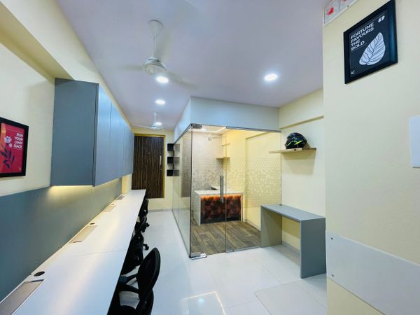 Modern office space with glass meeting room and sleek workstations.