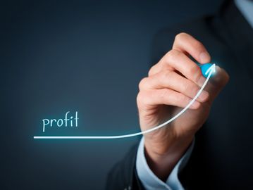 Hand drawing an upward profit graph.