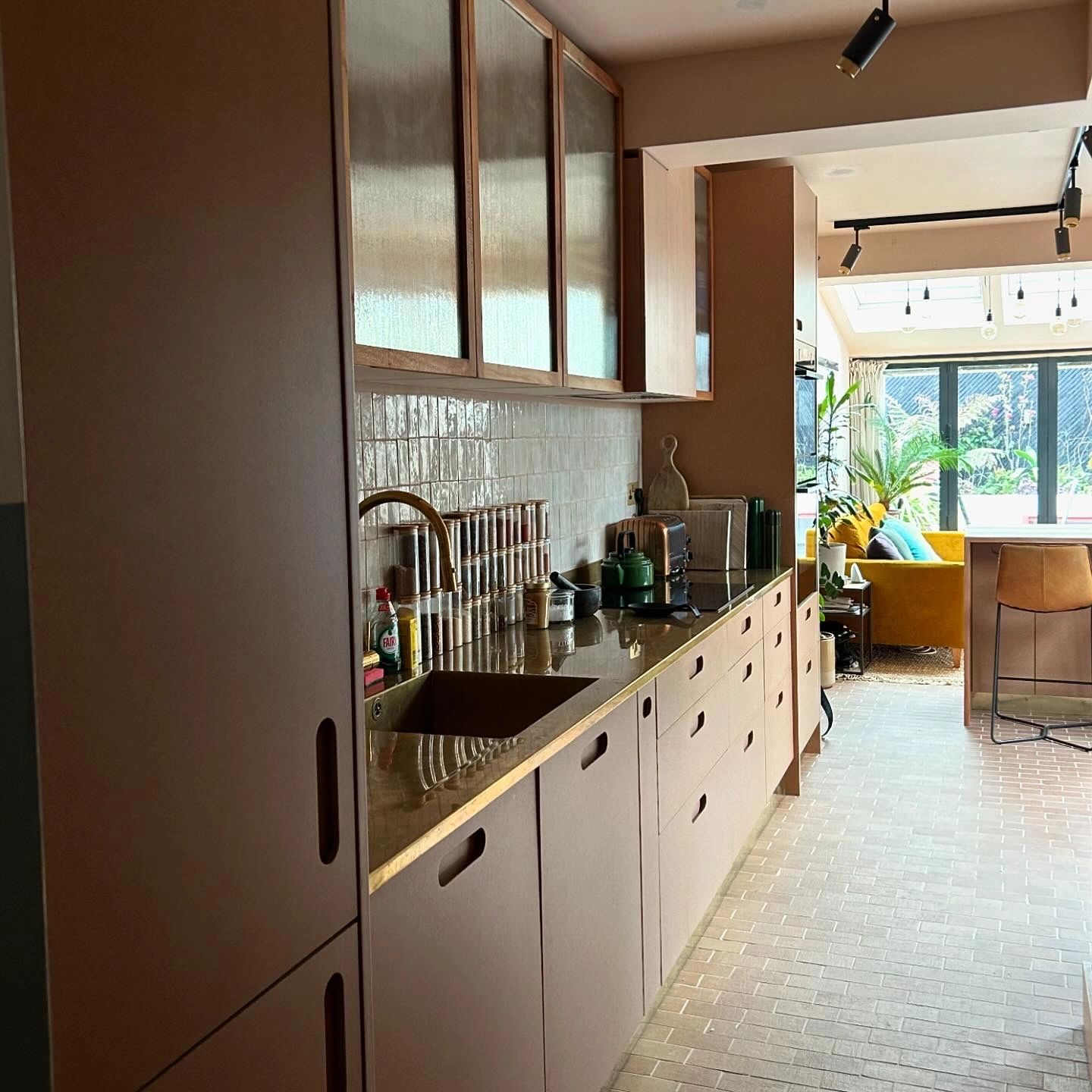 Bespoke Kitchen - birch plywood with cork and london plane. Reeded glass london plane cabinets. Bras