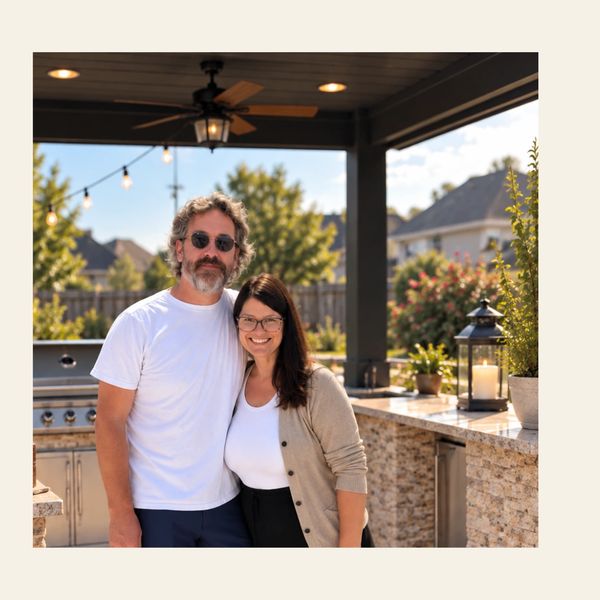 Couple smiling outdoors on a sunny day.