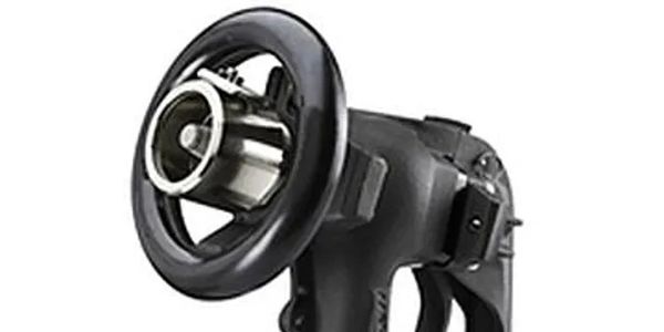 Black handheld power tool with circular attachment.