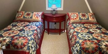 Two twin beds with star quilts.