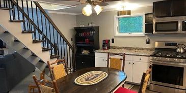 Dining table by kitchen stairs.