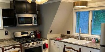 Kitchen with stove and microwave.