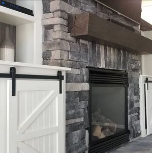 Stone veneer gas fireplace surround with built-in bookcases. 