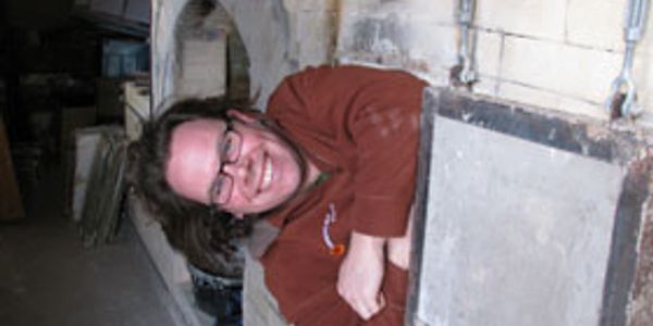 Michael Doxey in the firebox of his kiln