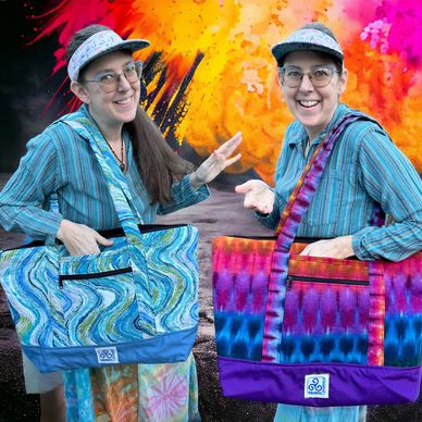 2 women each holding a big bag with their hand in a pocket.  one is tie dyed the other is blue waves