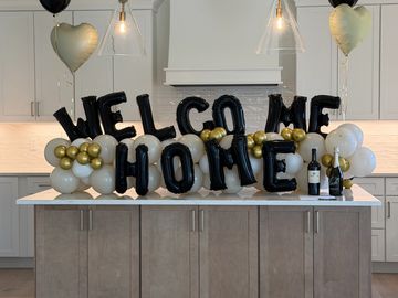 Welcome home balloon decoration on kitchen counter.