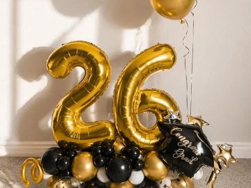 Golden and black balloons celebrating 26th.