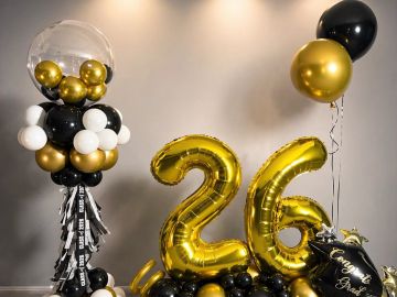 Golden and black balloon decorations with number 26.