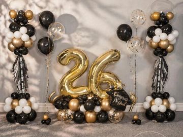 Black, gold, and white balloon decoration for a 26th celebration.