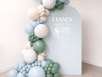 Golf-themed balloon decoration for Liam's hole in one.