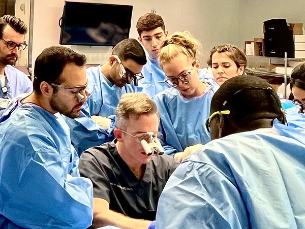 John M. Felder, MD teaches young plastic surgeons at a plastic surgery flap dissection course