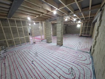 Basement under construction with radiant floor heating pipes installed.
