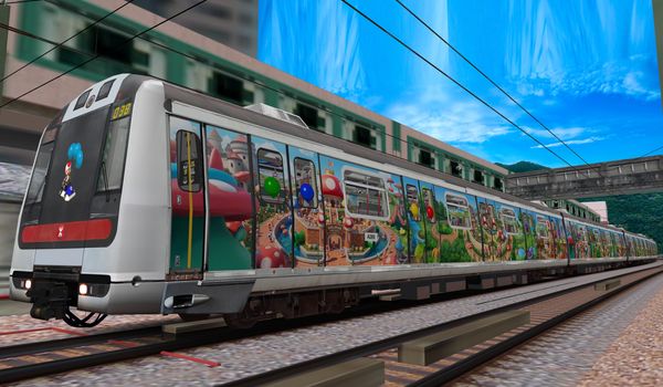 A colorful train decorated with cartoon characters on a railway track.