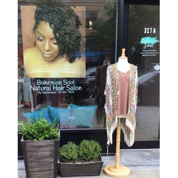 Bohemian Soul  storefront with plants and a mannequin.