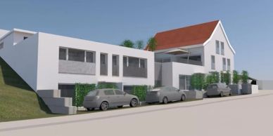 Modern residential building with parked cars and greenery.