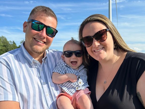 Happy family wearing sunglasses outdoors.