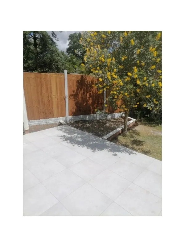 Expertly installed porcelain patio, fence posts and fence panels. contrasting fencing.