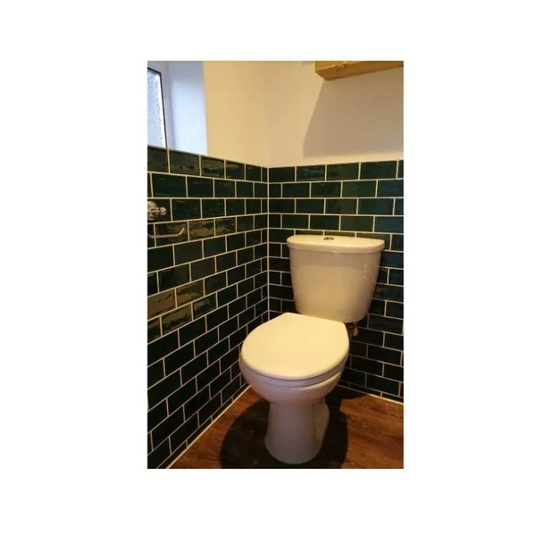 Cloakroom tiling. deep green, glossy metro tiles installed in Dorking using brick bond. 