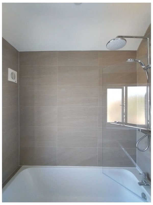 Natural beige bathroom wall tiles installed in a modern horizontal layout in Ranmore.