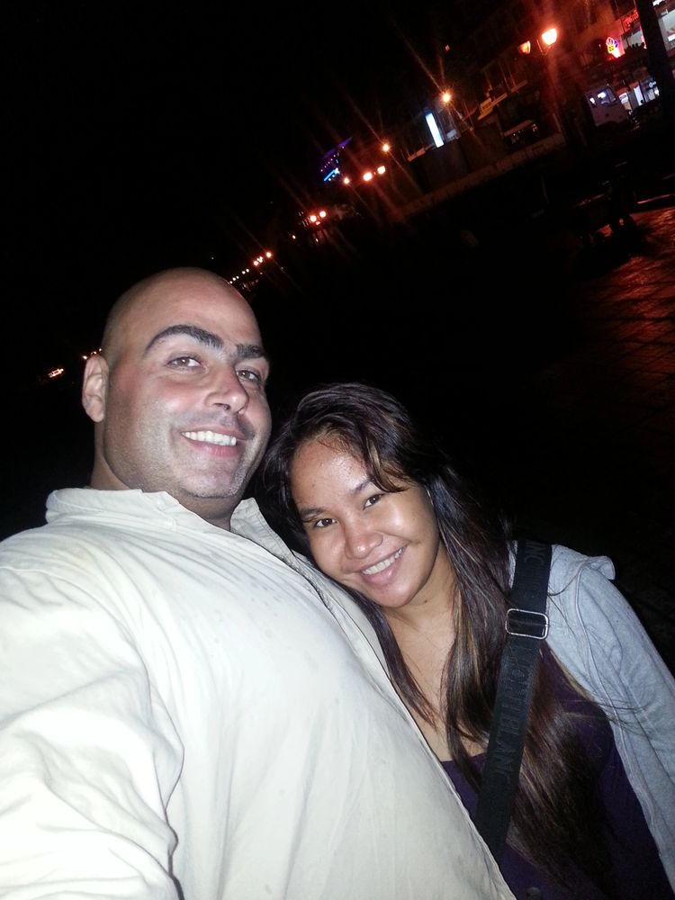 Stack of books next to pencils in a holder and a camera.