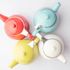 colorful display of turquoise, red lime and white 24oz teapots