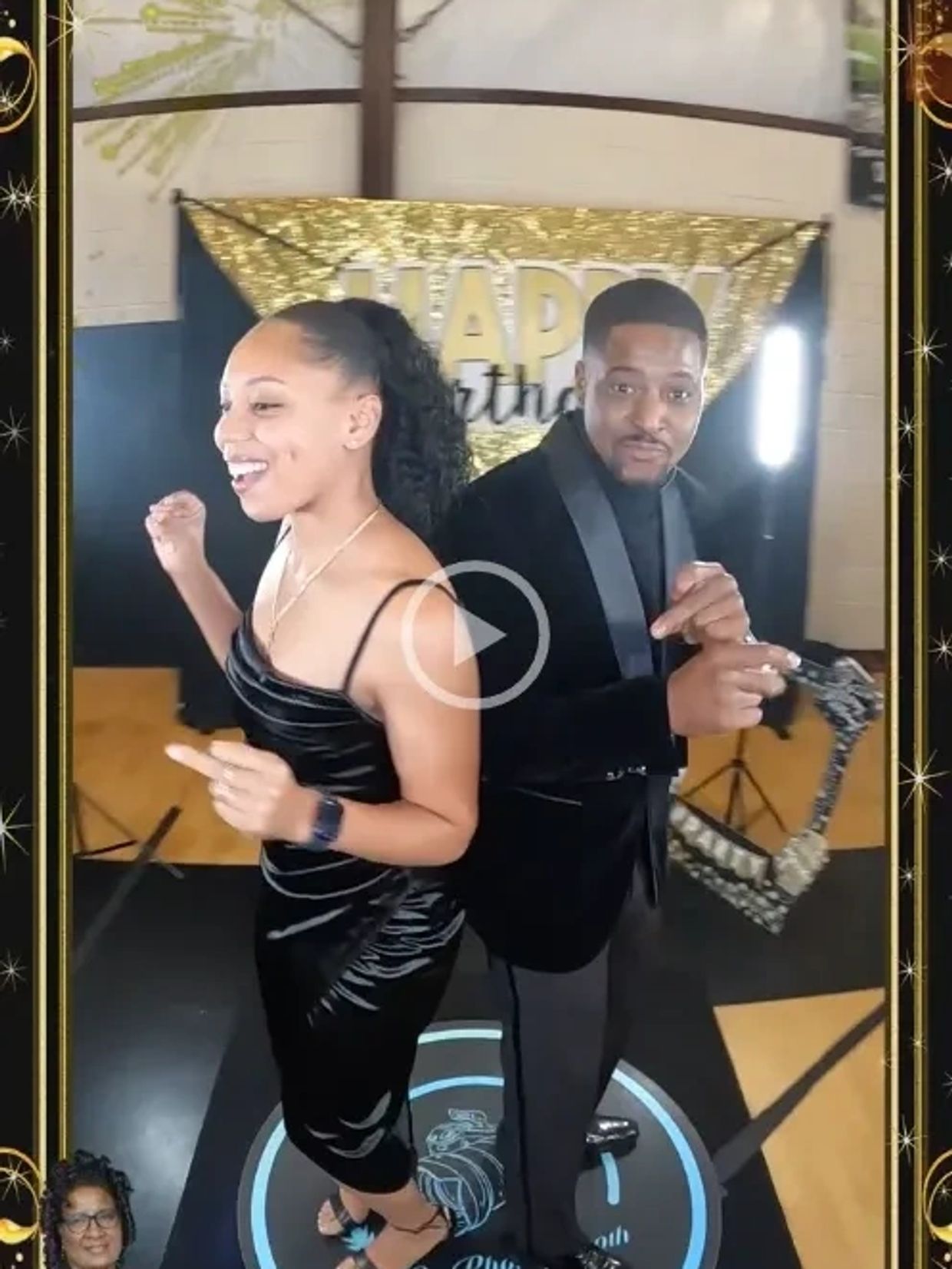 Two people celebrate at a birthday party with a sparkling backdrop.