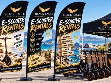 E-scooter rental setup by the beach with promotional flags.