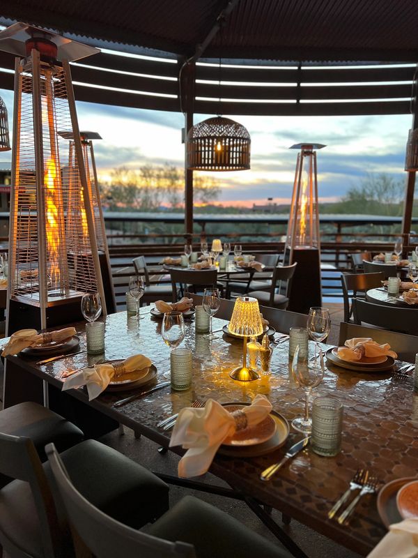 Dining patio at sunset, fully set for service