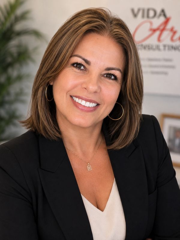Smiling professional woman with brown hair in a black blazer.