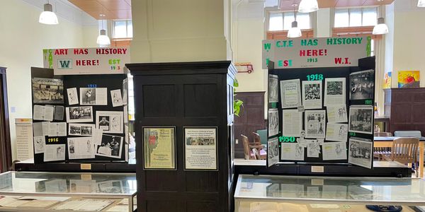 Exhibit boards showcasing art and history in a library.