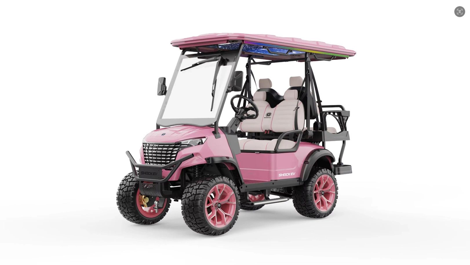 Pink electric off-road golf cart with rugged tires.