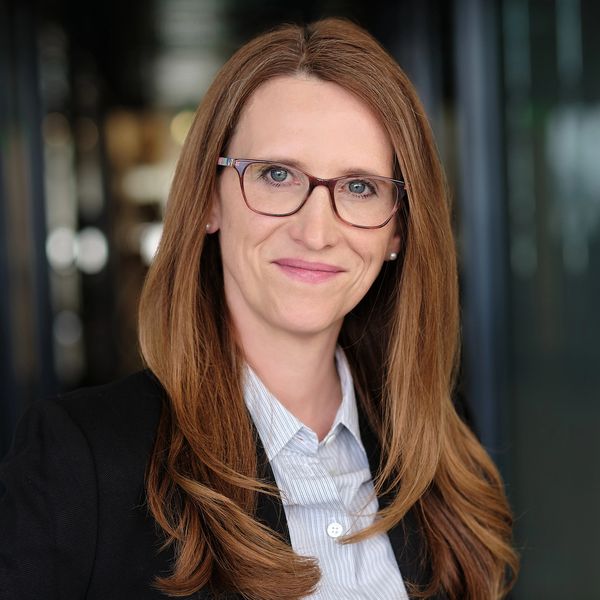 Professional woman with glasses smiling.