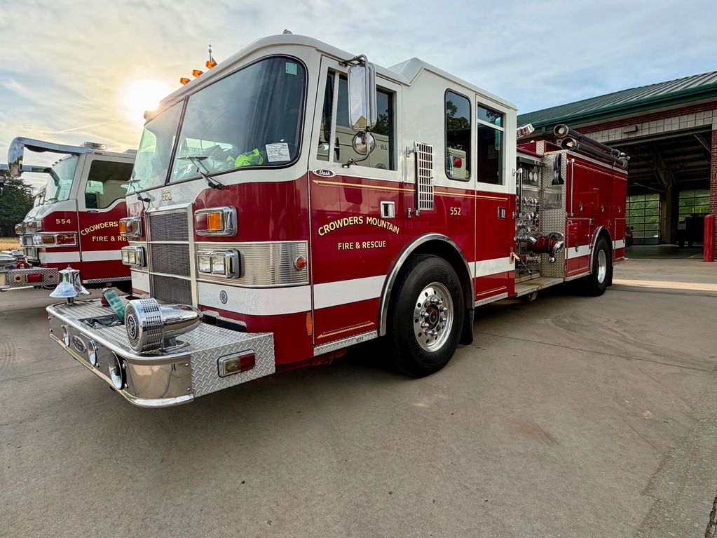Crowders Mountain Fire &amp; Rescue fire trucks parked outside a station.