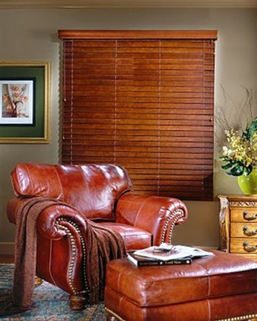 A wooden window blind behind a couch