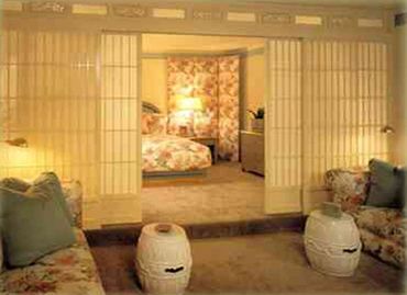 A bedroom with a shoji divider