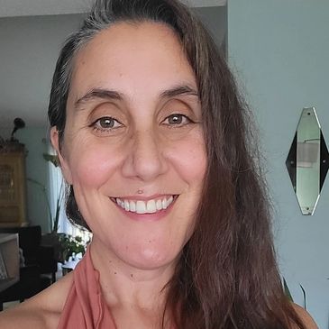 Smiling woman with long hair.