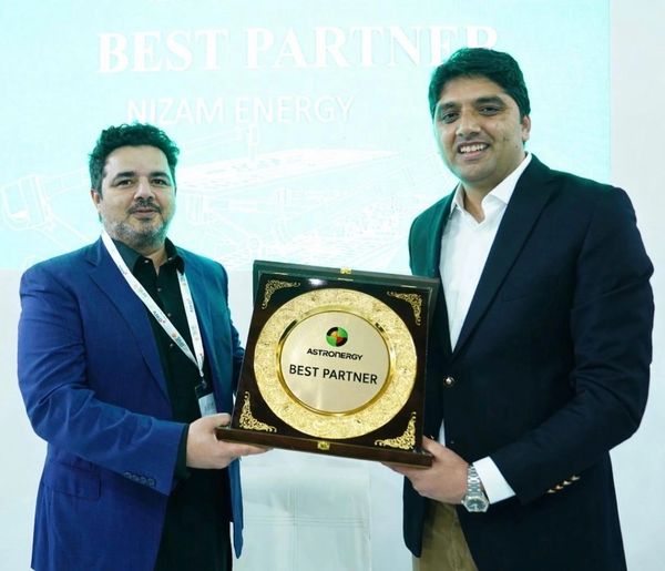 Two men holding a Best Partner award plaque.