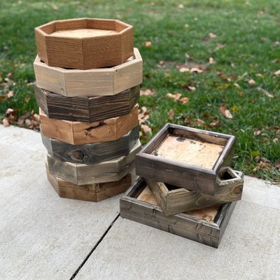 Stack of handcrafted wooden small bird taxidermy bases, including octagon and square designs