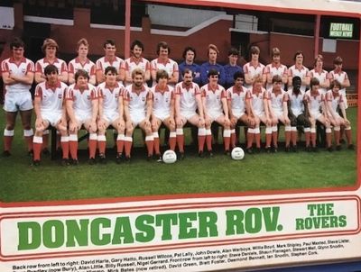 Vintage photo of Doncaster Rovers football team posing on a field with soccer balls.