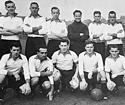 Vintage black-and-white photo of a soccer team lined up.