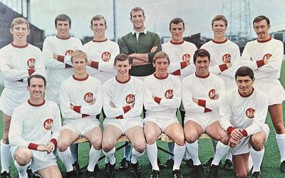 Vintage soccer team in white uniforms posing for a photo.