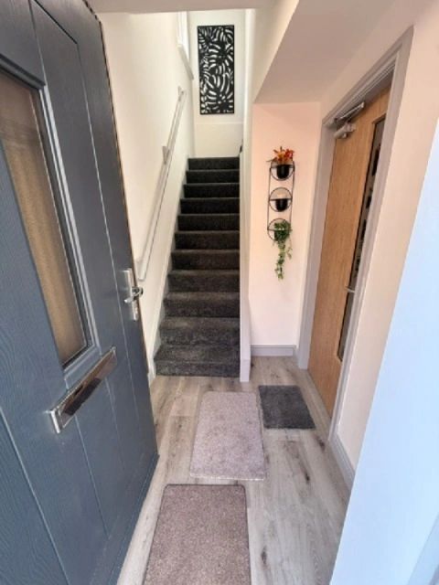 Entryway with stairs and doormats.
