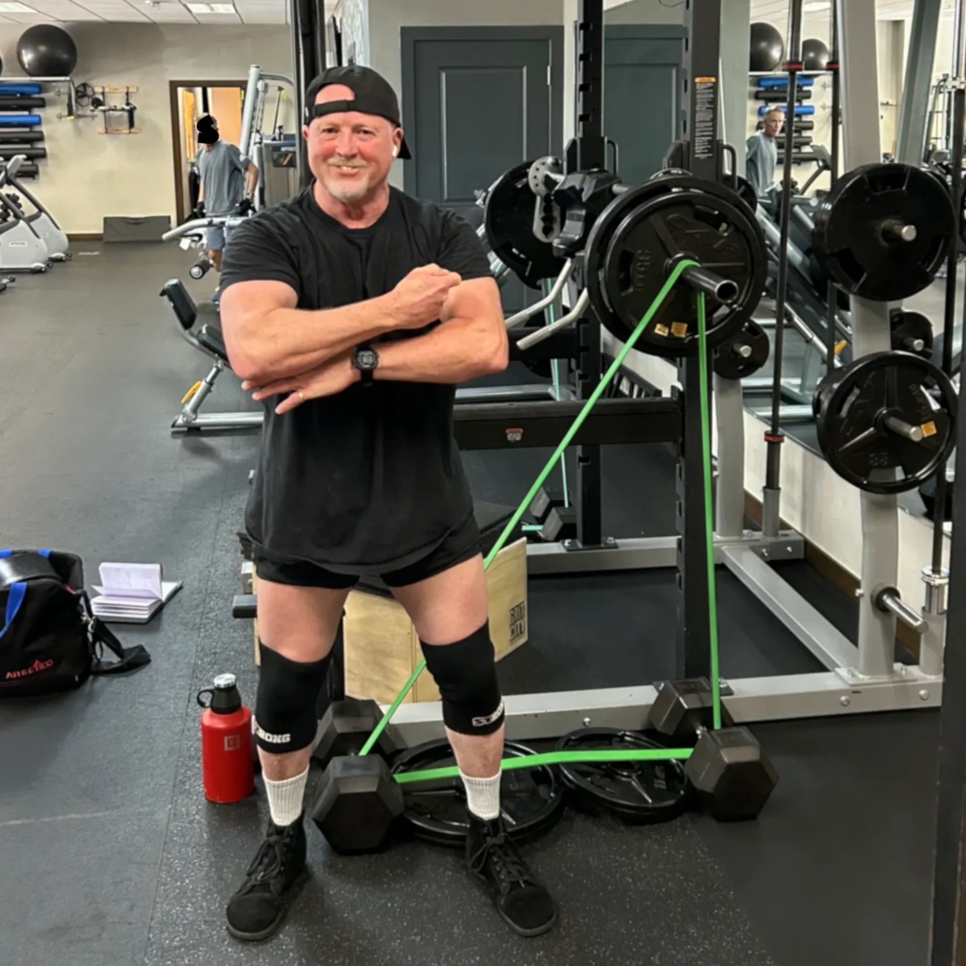 Man flexing muscles in a gym.